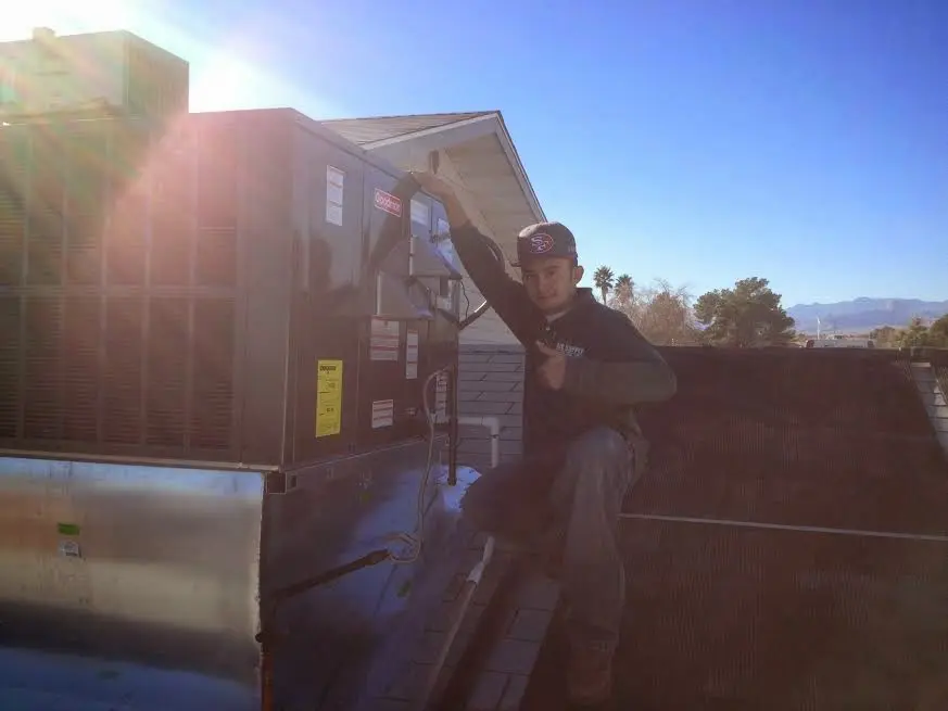 HVAC technician performing AC Tune-Up on a rooftop unit in Short Pump
